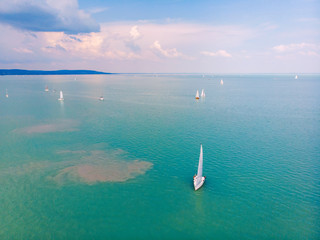 Aerial view of the beautiful blue water of Lake Balaton with sailing boats on the Tihany coast