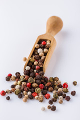 mix of peppercorns on white acrylic background