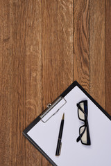 Notepad with pen stationery accessories beige background