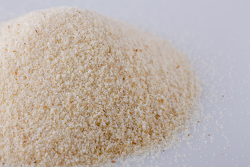 natural organic semolina on white acrylic background