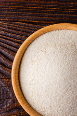 natural organic semolina on dark wooden rustic background