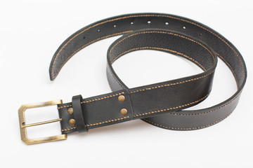 Collapsed trouser belt, brown stitched with yellow thread.