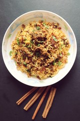 Mutton Biryani or Lamb Pulao. Garnished with fried onion & chopped coriander. Biryani is a famous Spicy non vegetarian dish of India. Goat meat cooked along with Basmati rice & spices. 