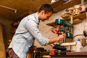 Carpenter works in a workshop for the production of vintage furniture
