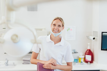 Happy young dental nurse wearing a face mask