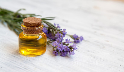 Obraz na płótnie Canvas Glass bottle filled with lavender oil. Natural cosmetics, herbal medicine concept