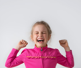 Little girl preschooler screaming with anger shutting tightly her eyes and clenching fists. Childhood, facial expression, emotion, hysteria, stop it, enough. Close up studio portrait isolated on white