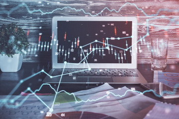 Double exposure of forex chart and work space with computer. Concept of international online trading.