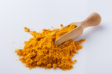 natural turmeric powder on white acrylic background