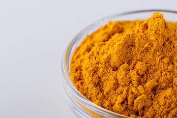 natural turmeric powder on white acrylic background