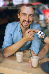 Portrait of happy man holding hand of woman