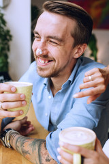 Smiling man with cappuccino foam on nose