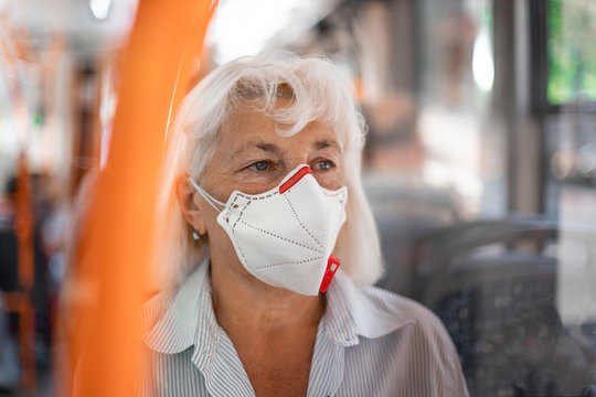 Coronavirus, Covid 2019 Virus Protection. Woman With Respiratory Mask Traveling In The Public Transport By Bus