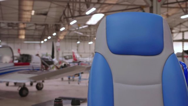 Closeup on a blue leather seat in a hangar, slowmotion