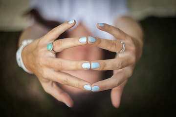 Woman demonstrates her manicure on her hands.