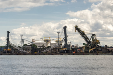 Fototapeta na wymiar COAL TERMINAL - The transshipment quay in the seaport and the gas terminal tanks in the background