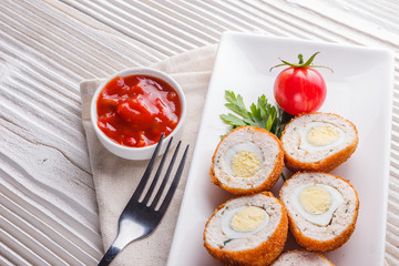 Scotch egg meat balls on rustic wooden background