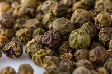 spicy green peppers on white acrylic background