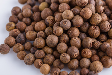 fresh spicy peppers allspice on white acrylic background