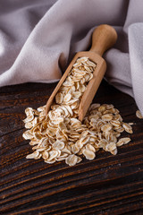 Fototapeta na wymiar raw oatmeal on a wooden rustic background