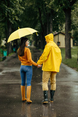 Love couple with umbrella walking in rainy day