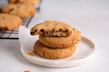 Oatmeal cookies with raisins and nuts on a white background.