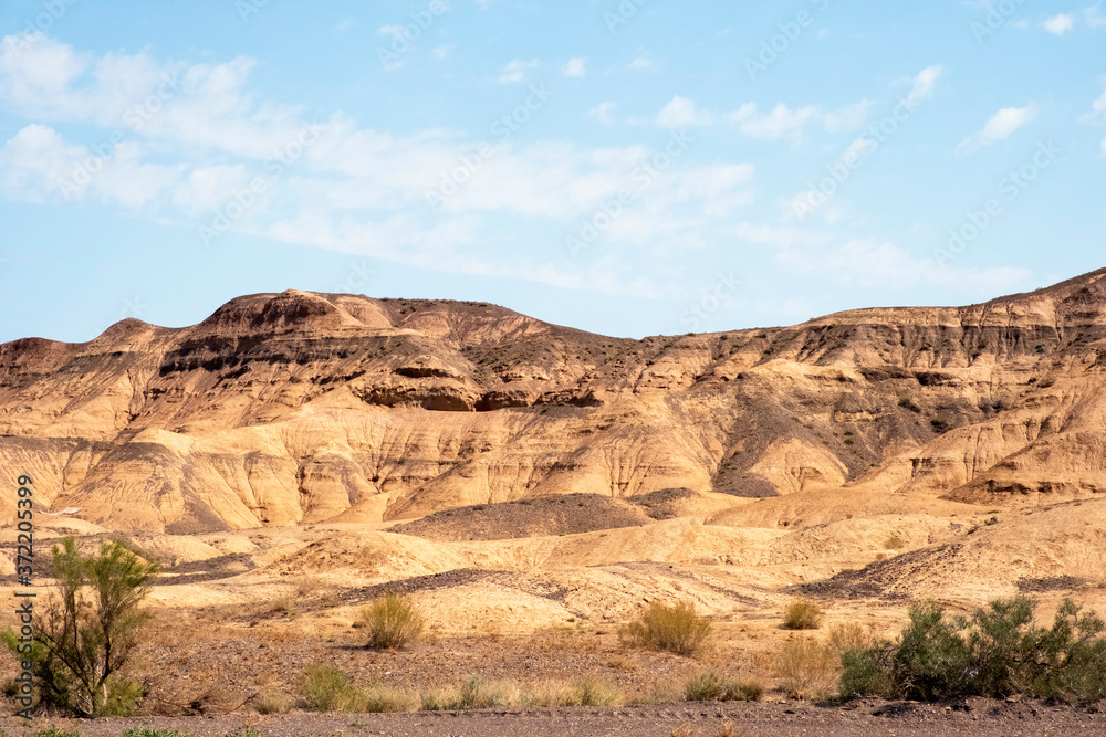 Wall mural charyn national park in kazakhstan. clouds background. beautiful sand stone formations. soil errosio