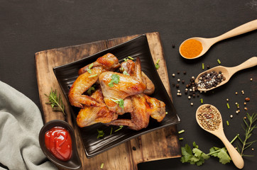 Rosemary Roast Chicken is arranged in an appetizing black plate ready to be served. And tomato sauce spices chili arranged on the black table top view