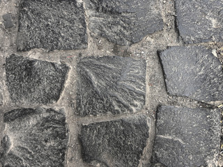Grey stone set irregularly grey granite stone wall texture and background
