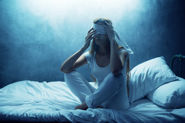 Naklejka premium Blindfolded psycho woman in bed, psychedelic