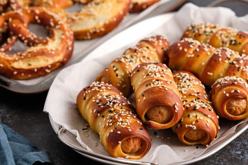 Pretzel dogs with sausages on black background. Oktoberfest.