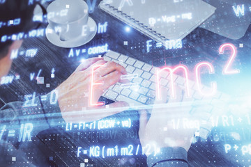 Science formula hologram with man working on computer on background. Education concept. Double exposure.