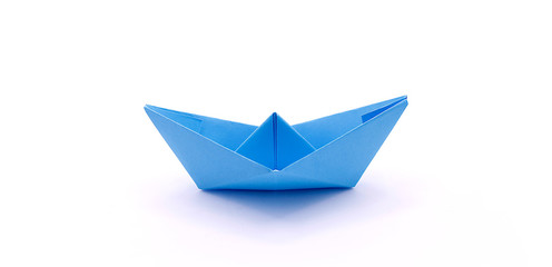 Paper boat made of colored paper close-up on a white background