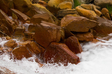 Mountain river, water and red rocks