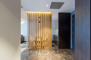 See-through decorative wooden wall that separates dining area from living room