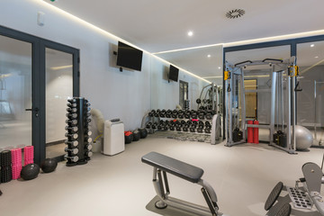 Fototapeta premium Interior of a hotel gym with equipment