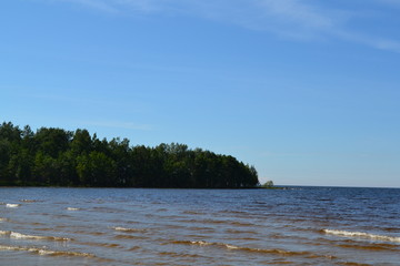sandy shore of the Northern lake on a Sunny day