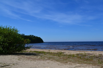 sandy shore of the Northern lake on a Sunny day