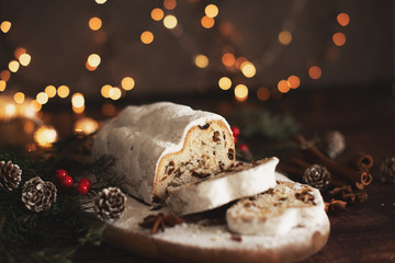 Traditional German Christmas cake - Cranberry Stollen, Christmas tree, ornaments, and candles.