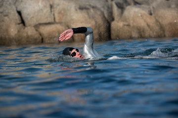 Athlete swimming in the ocean.