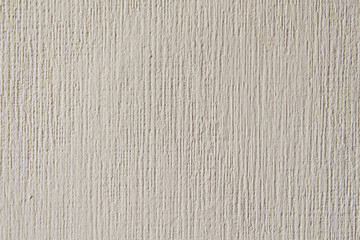 The texture of the white painted wall. Vertical stripes