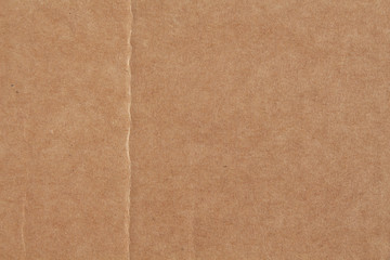 Texture of old crumpled cardboard with a fold