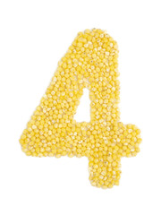 Arabic numeral 4 from grain of millet on isolated white background.