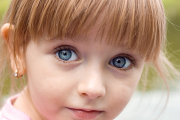 Portrait of beautiful cute little girl face close-up, look of innocence blue eyes