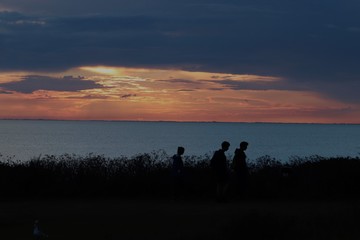 Hunstanton beach sun set over the sea ,glowing deep orange ball of fire 