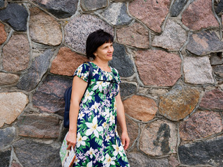 girls by a high stone wall in summer