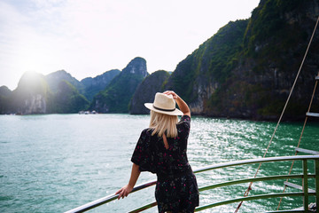 Woman admiring rock formations in Ha Long Bay Vietnam