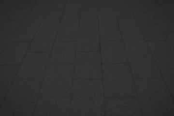 Black concrete paver block floor pattern for background.