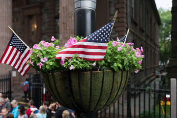 Hanging basket of flowers with American flags