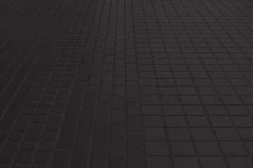 Black concrete paver block floor pattern for background.